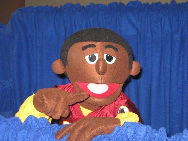 Black male puppet doing a show